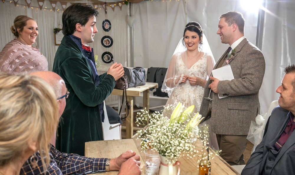 Jay Gatling performs close up magic for a bride and groom.