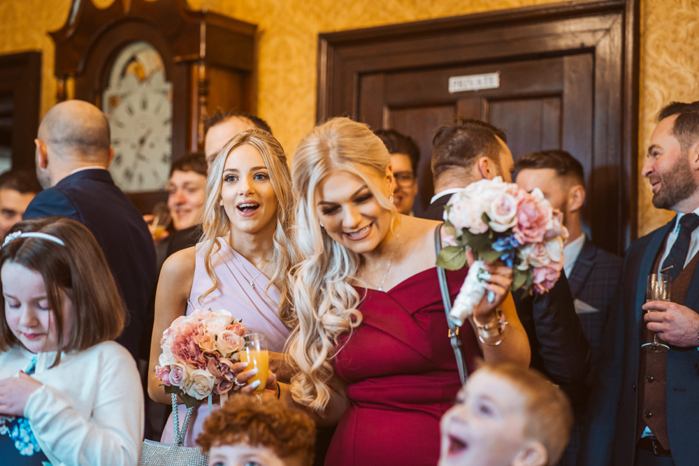 Adults enjoying a wedding magician's performance