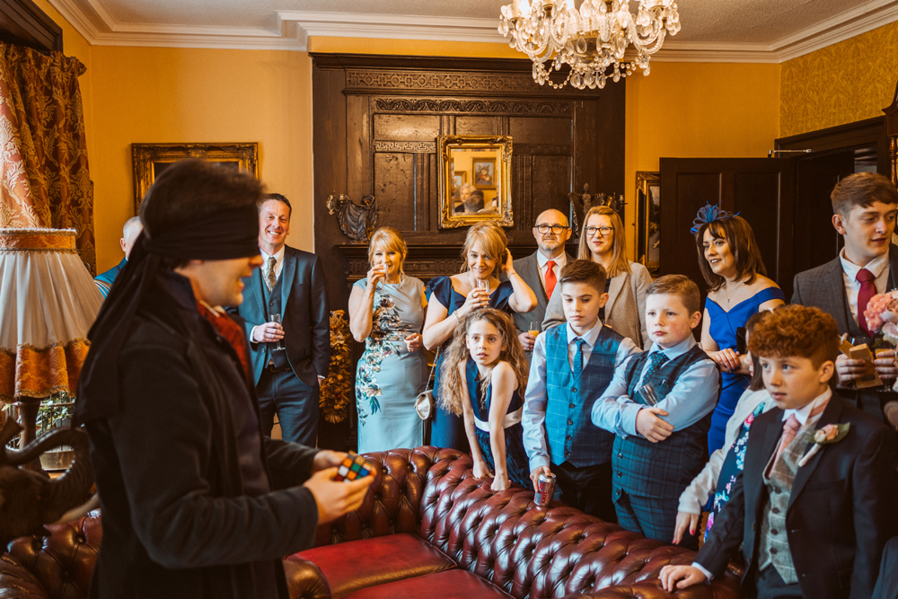 Guests at a wedding watching a magician perform